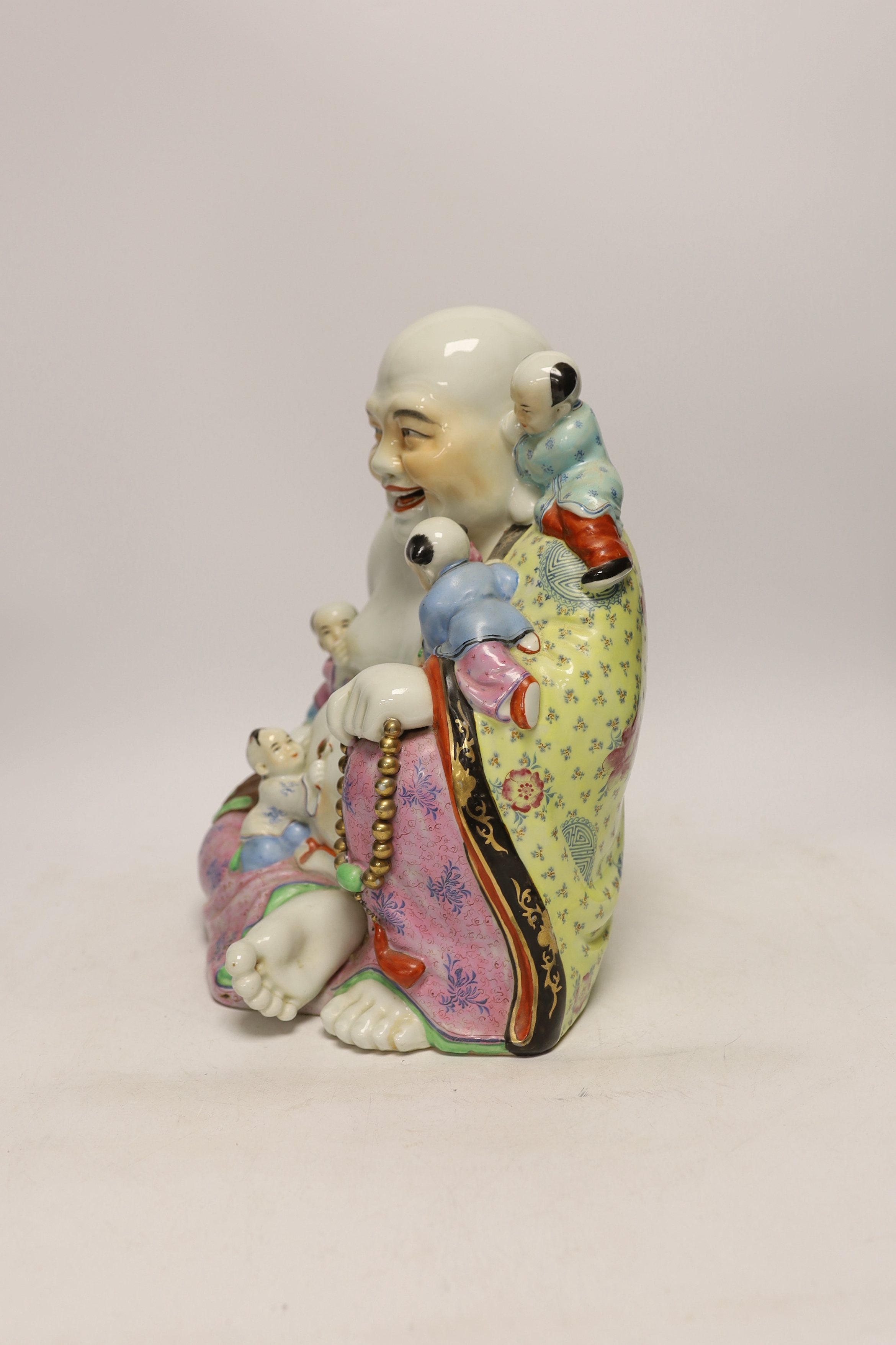 A Chinese enamelled porcelain group of laughing Budai with children, mid 20th century, 31cm high